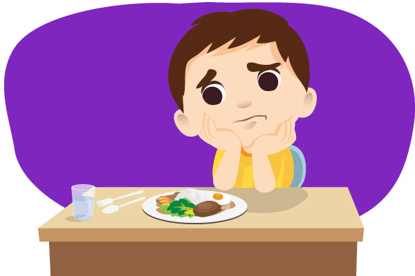 Niño mirando fatigado el plato de comida