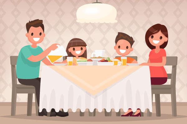 Familia sentada comiendo a la mesa