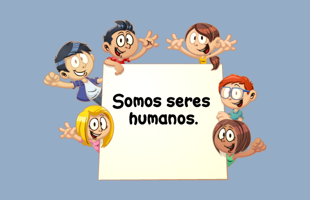 Niños y niñas rodeando un cartel que dice "Somos seres humanos"